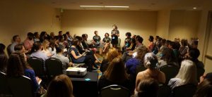 Uncommon Women Panel - participants look on as Kelsey Merkley introduces the Uncommon Women panel at OpenEd17